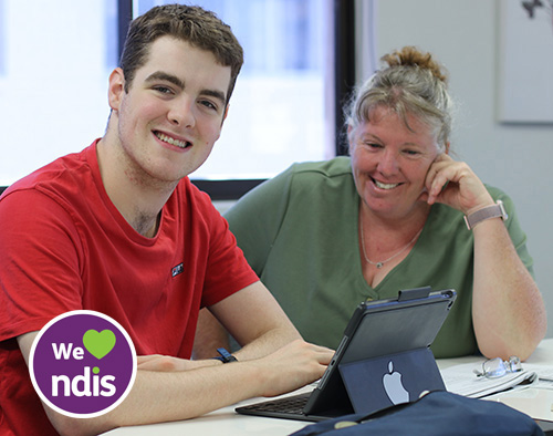 Person with support coach on iPad