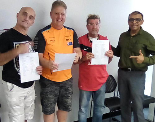  Three CTA participants with their Facilitator, smiling and posing together after completing their program.